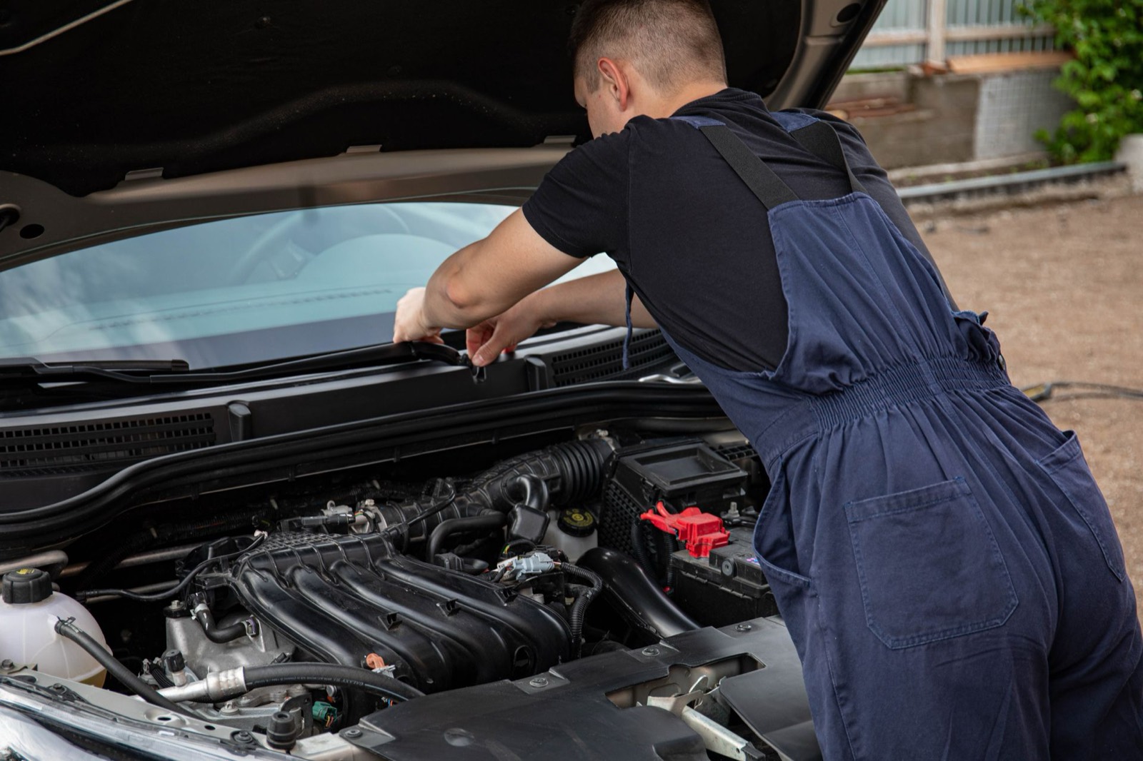 Mobile mechanic servicing a car on a home driveway in Cambridgeshire